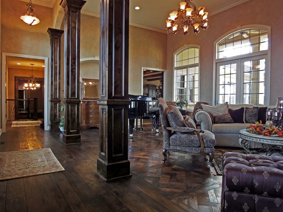 spacious room with a piano and hardwood parquet flooring