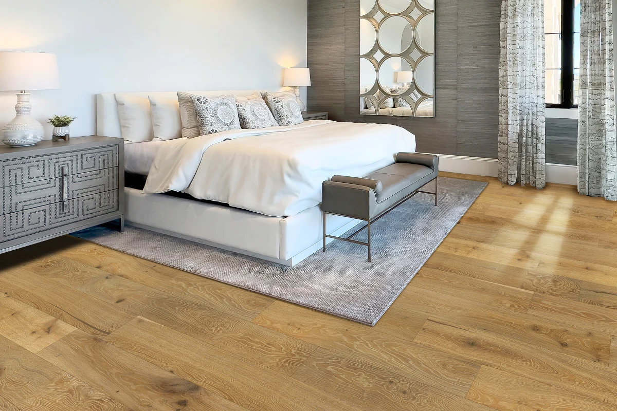 Modern bedroom featuring Silver Oak Reserve Forest hardwood flooring, elegant bed with decorative pillows, stylish nightstand, and contemporary decor elements.