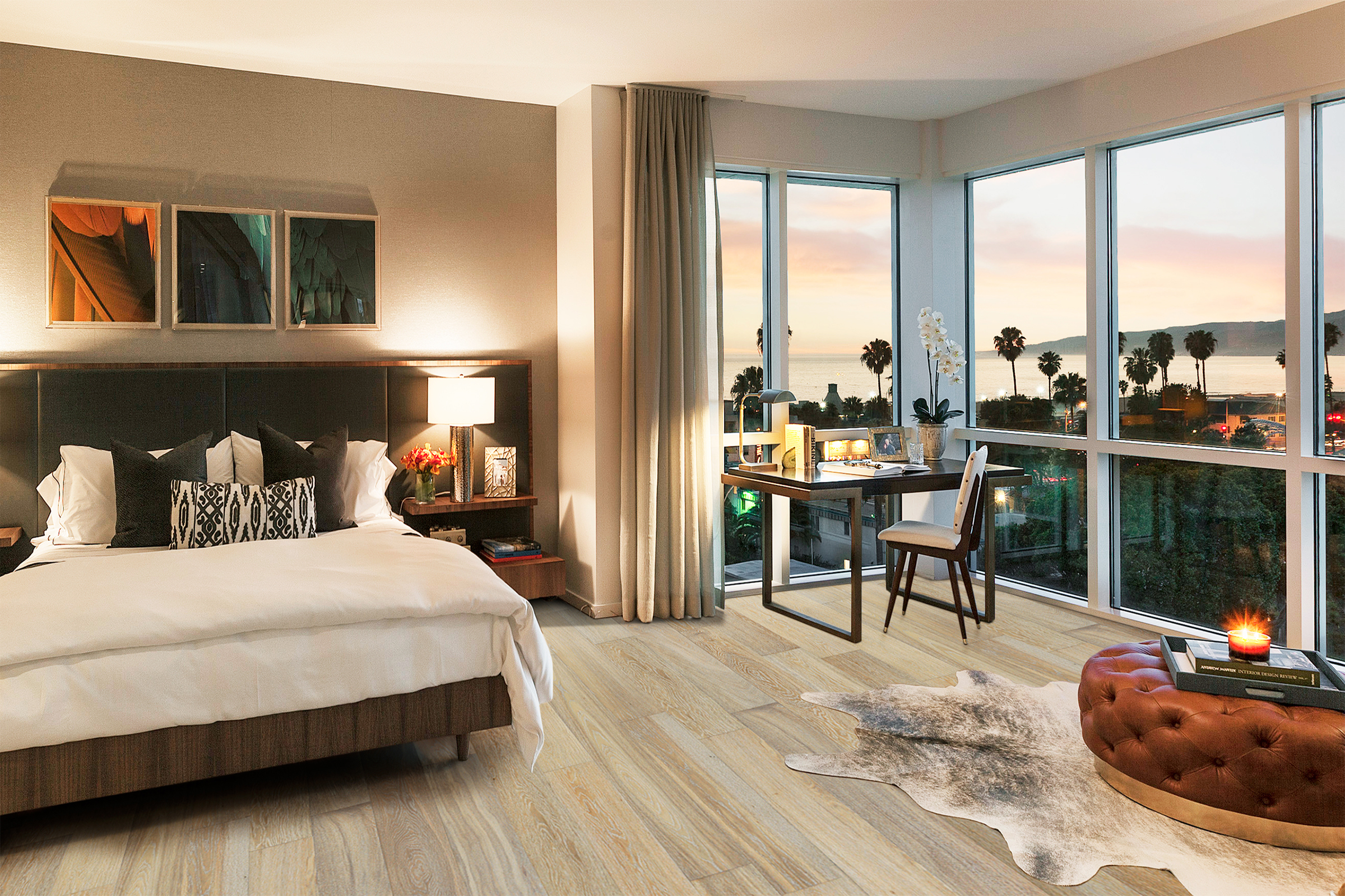 Modern bedroom interior featuring Sandbank hardwood flooring, a cozy bed with decorative pillows, stylish desk with ocean view, and warm lighting accents.