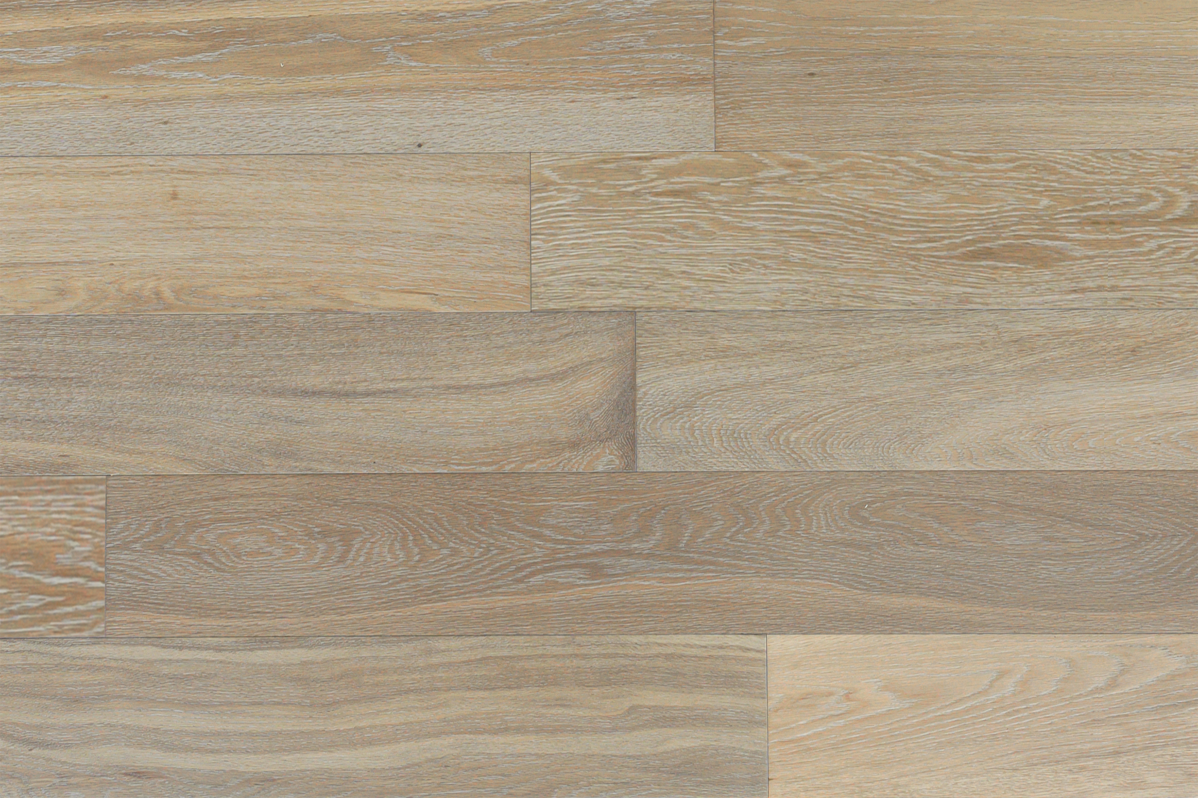 Sandbank hardwood floor swatch from D&M Studio Line, showcasing a modern coastal-inspired hue with light and textural depth, featuring organic grain patterns in European Oak, 6" wide planks.