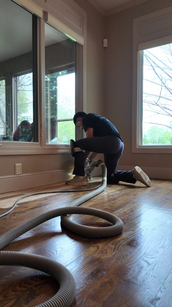 contractor doing dustless hardwood floor refinishing in a residential kansas city home