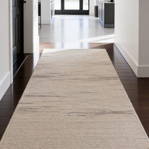 beige colored rug protecting the hardwood floor in the entryway of a residential home in kansas city